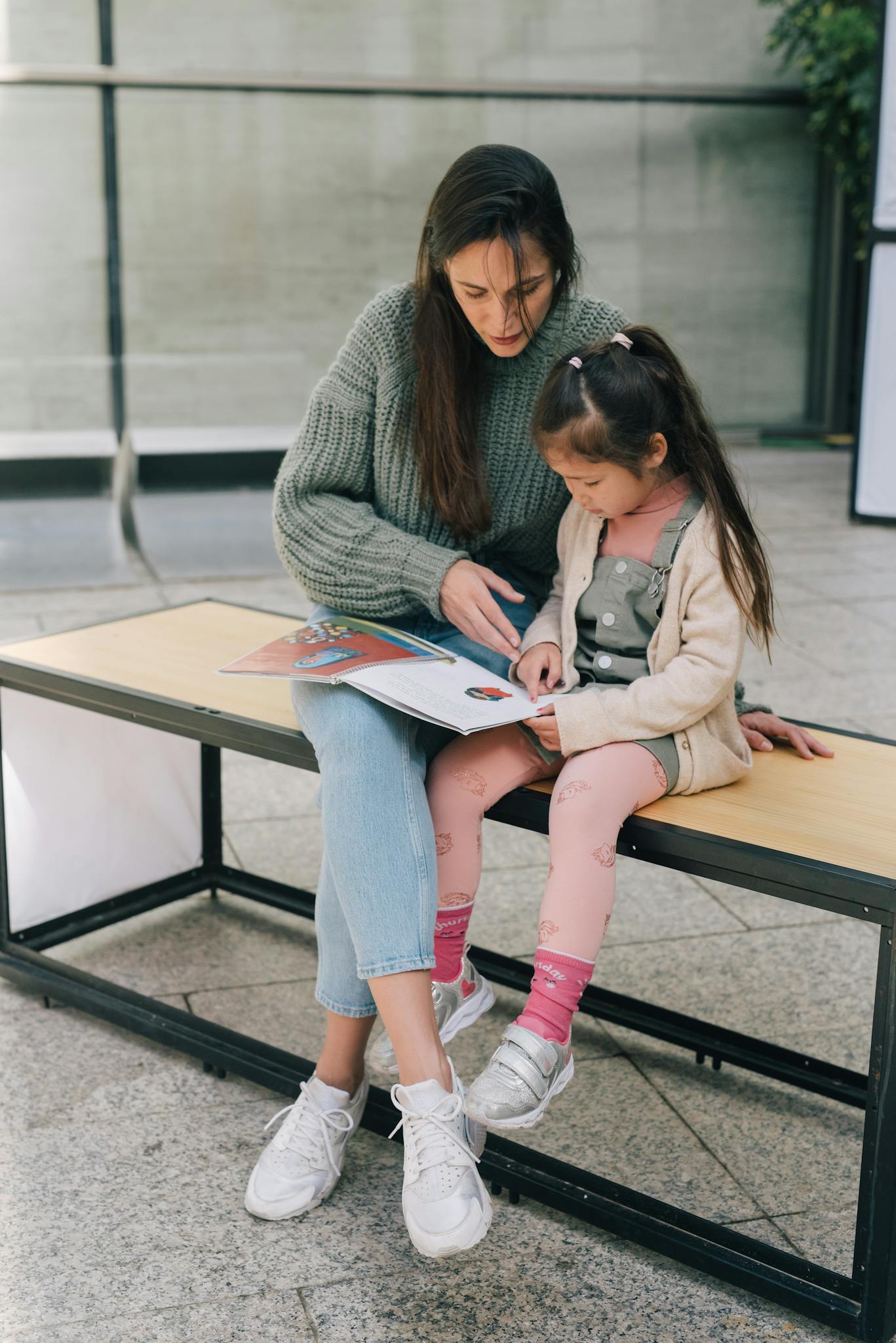 Együttműködések 3 a mother and daughter enjoy reading a